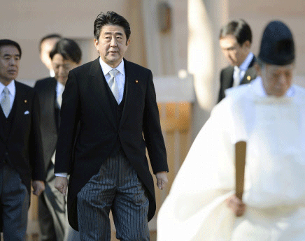 Japanese Prime Minister Shinzo Abe is led by a shinto priest as he pays a customary New Year's visit at Ise shrine in Ise, Japan. Reuters