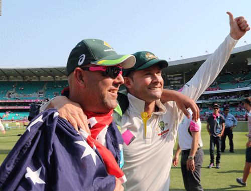 Australia's captain Michael Clarke, right, and coach Darren Lehmann walk together after winning their Ashes cricket test match against England in Sydney Sunday, Jan. 5, 2014. Australia won the match by 281 runs and the Ashes series 5-0. AP Photo