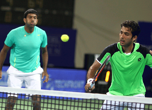 Indian tennis player Rohan Bopanna and Pakistan's Aisam ul-Haq Qureshi in action against Stanislas Wawrinka of Switzerland and Benoit Paire of French during their first round of men's doubles for ATP Chennai Open 2014 in Chennai on Tuesday. Rohan Bopanna and Aisam ul-Haq Qureshi won the match (6-4,4-6,11-9). PTI Photo