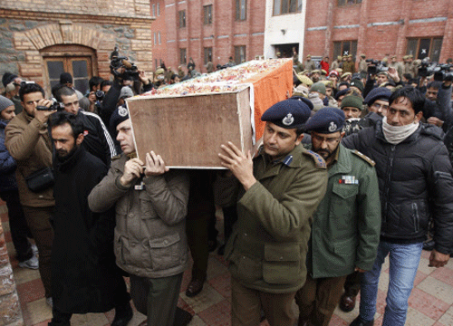 inconsolable: Relatives of the policeman killed in a shooting between suspected militants and security forces in the  northern town of Sopore grieve at his wreath-laying ceremony in Srinagar on Tuesday. AFP