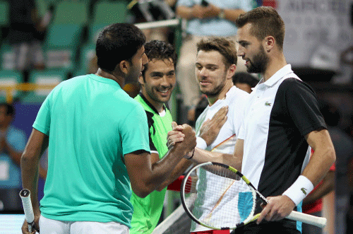 India's Rohan Bopanna and Pakistan's Aisam ul-Haq Qureshi shaking hands with Stanislas Wawrinka of Switzerland and Benoit Paire of French after winning their first round of men's doubles for ATP Chennai Open 2014 in Chennai on Tuesday. Rohan Bopanna and Aisam ul-Haq Qureshi won the match (6-4,4-6,11-9). PTI Photo
