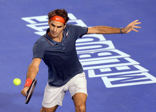 Roger Federer of Switzerland plays a backhand during a gala charity exhibition match in the lead up to the Australian Open against Jo-Wilfried Tsonga of France at Rod Laver Arena in Melbourne, Australia, Wednesday, Jan 8, 2014.The charity event for the Roger Federer Foundation and the Australian Tennis Foundation will raise money for the education of African children. AP