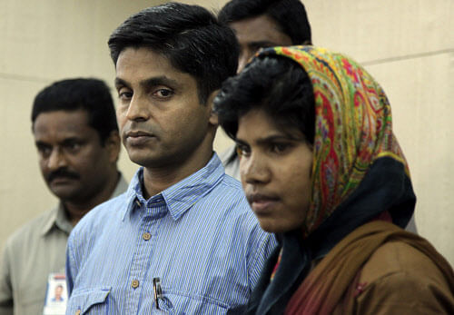 Maoist leader G. Venkatakrishna Prasad alias "Gudsa Usendi" and his wife Santhoshi Markam are produced in front of the media in Hyderabad, India, Thursday, Jan. 9, 2014. The Maoist leader is suspected to be the mastermind behind the killing of dozens of paramilitary soldiers and the ambush of a convoy of Congress party leaders last year in Chhatisgarh state. Prasad is reported to have surrendered because of ill health. AP Photo