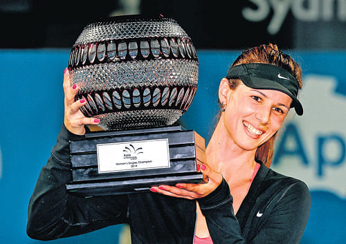 on cloud nine: Tsvetana Pironkova poses with her spoils after winning the Sydney International on Friday. AP