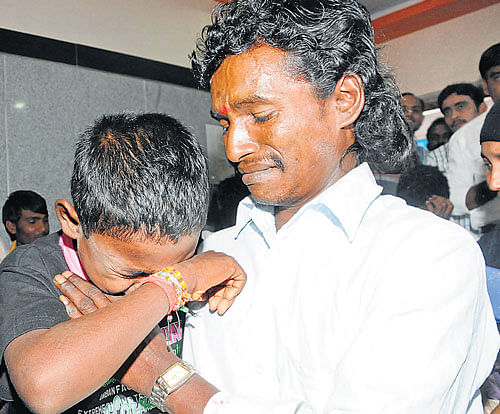 A parent breaks down after being reunited with his child at an event organised by Society for Assistance to Children in Difficult Situation, in the City on Friday. DH Photo