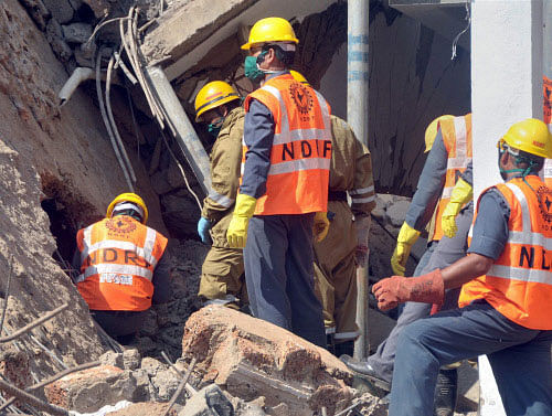 NDRF personnel busy in rescue after the under construction building collapsed at Canacona, Goa. PTI Photo