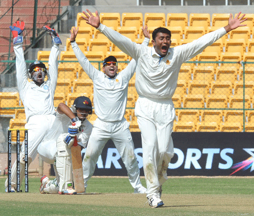 Karnataka's Shreyas Gopal sucessfully appeals the LBW dismissial of Mumbai's Hiken Shah in the 2nd innings during the ongoing Ranji Cricket match at Chinnaswamy Stadium in Bangalore on Wednesday. DH photo