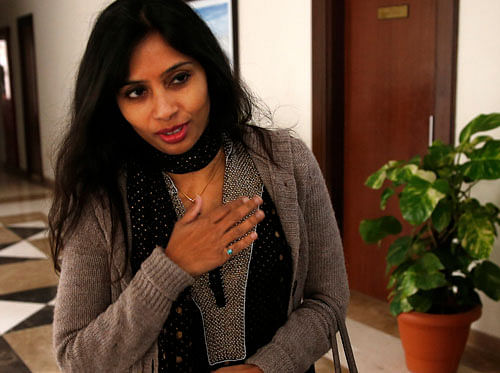Devyani Khobragade, who served as India's deputy consul general in New York, greets journalists as she leaves Maharastra Sedan state house in New Delhi, India, Saturday, Jan. 11, 2014. Khobragade, 39, is accused of exploiting her Indian-born housekeeper and nanny, allegedly having her work more than 100 hours a week for low pay and lying about it on a visa form. Khobragade has maintained her innocence, and Indian officials have described her treatment as barbaric. (AP Photo/Saurabh Das)