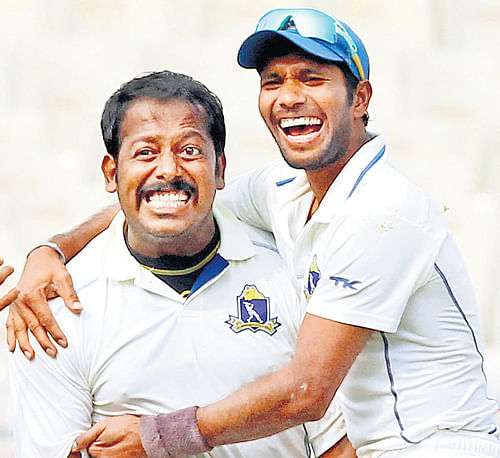 Bengal's Shib Shankar Paul (left) and Ashok Dinda celebrate their win over Railways in the Ranji Trophy quarterfinals at the Eden Gardens on Sunday. PTI Photo