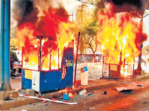 Fiery protest: A toll booth was burnt and five others vandalised when an anti-toll agitation took a violent turn in Kolhapur, Maharashtra, on Sunday. PTI