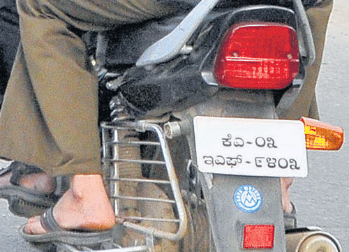 what's in a language? Traffic police personnel are finding it difficult to jot down registration number of vehicles with Kannada numberplates. dh photos