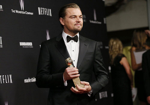 Actor Leonardo DiCaprio poses with the award for Best Actor in a Motion Picture, Musical or Comedy for his role in 'The Wolf of Wall Street' at The Weinstein Company & Netflix after party after the 71st annual Golden Globe Awards in Beverly Hills, California January 12, 2014. REUTERS/Danny Moloshok