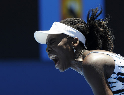 Venus Williams of the U.S. yells in frustration during her first round loss to Ekaterina Makarova of Russia at the Australian Open tennis championship in Melbourne, Australia, Monday, Jan. 13, 2014. (AP Photo/Andrew Brownbill)