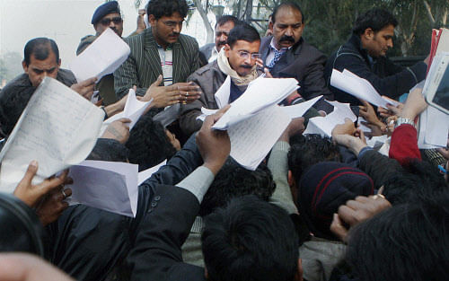 New Delhi: Delhi Chief Minister Arvind Kejriwal collecting papers regarding people's grievances during his inaugural 'Janata Darbar' or public hearing at Delhi Secretariat in New Delhi on Saturday. PTI Photo by Atul Yadav (PTI1_11_2014_000030A)