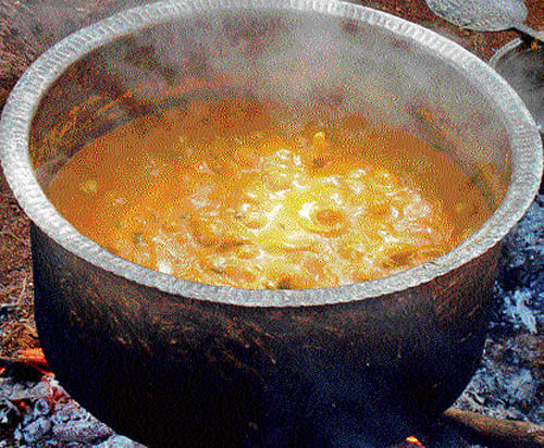 Hot 'mudkoley' boils away on a traditional stove. Photo by author