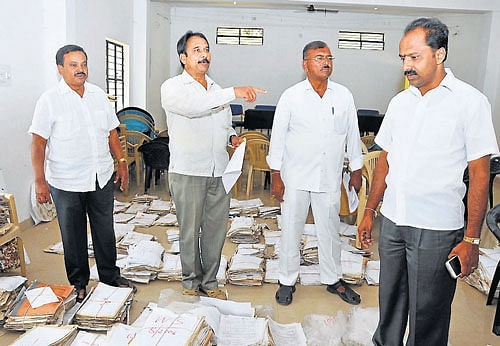 sea of files: Mysore City Corporation Finance Standing Committee member Shaukath Pasha, President B L Bhyrappa and member Manjunath during an inspection at Vani Vilas Water Works office, V V Mohalla, in Mysore, on Monday. DH Photo