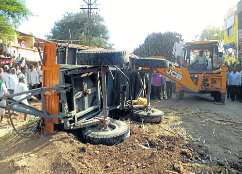 tragic: The sugar cane-laden tractor that overturned, killing nine people, near Jamkhandi in Bagalkot district on Monday. KPN
