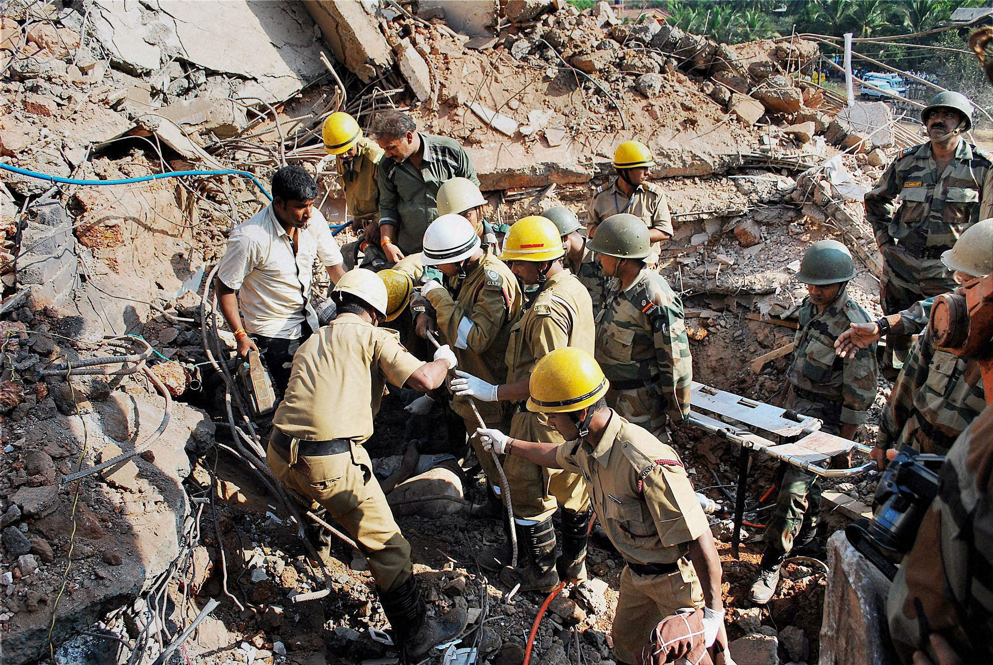 Army personnel and fire fighters during the joint rescue operation at the site of the five-storied building collapse accident, in Canacona, Goa. PTI File Image