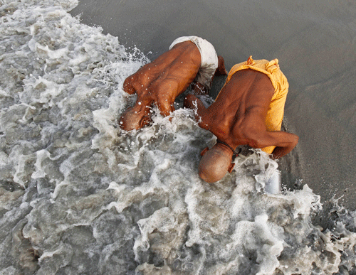 Pilgrims take a dip at the confluence of the Ganges River and the Bay of Bengal, an act which they consider to be holy, at Sagar Island, south of Kolkata.  Hindu monks and pilgrims are making their annual trip to Sagar Island for the one-day festival of 'Makar Sankranti' on January 14. Reuters