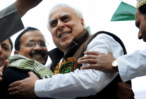 bygones be bygones: Union Minister Kapil Sibal and Delhi Chief Minister Arvind Kejriwal hug each other during an Eid Milad-un-Nabi procession in New Delhi on Tuesday. PTI