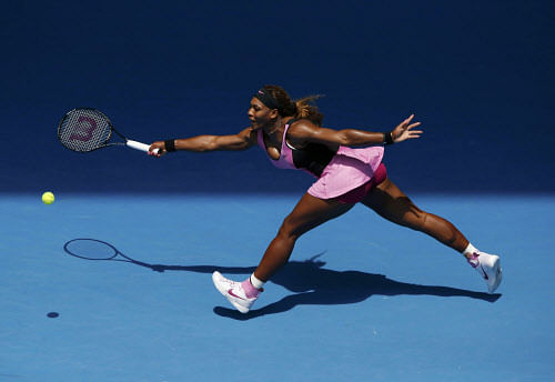 Serena Williams of the U.S. hits a return to Vesna Dolonc of Serbia during their women's singles match at the Australian Open 2014 tennis tournament in Melbourne January 15, 2014. REUTERS