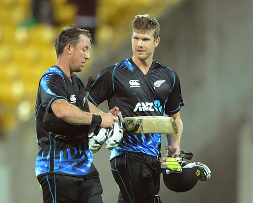 New Zealand's Luke Ronchi, left, and Jimmy Neesham leave the pitch after their team defeated West Indies in the second T20 International cricket match at Westpac Stadium in Wellington, New Zealand, Wednesday, Jan. 15, 2014. AP