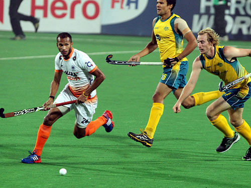 Indian player Sunil (24) and Australian players vie for the ball during their match of World Hockey League Final at Major Dhyan Chand National stadium in New Delhi on Wednesday. PTI Photo