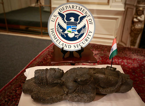 A male deity black sandstone sculpture, depicting a Bodhisattva, one of three sandstone sculptures stolen from India valued at over $1.5 million, is seen during a repatriation ceremony of the artefacts at the Indian consulate in New York, January 14, 2014. One of the pieces called the 'Vishnu Lakshmi' sandstone sculpture, stolen from the Gadgach Temple in Atru, Rajasthan, India was listed as Interpol's top 10 most wanted stolen works of art. REUTERS