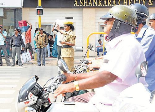 A DH file photo of a homeguard manning traffic in Mysore.
