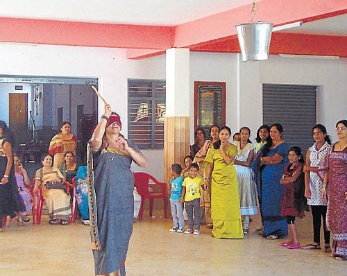 A woman takes part in a game, as part of the get-together, organised by the women's wing of Somwarpet Kodava Samaja, in Somwarpet, on Tuesday. DH Photo