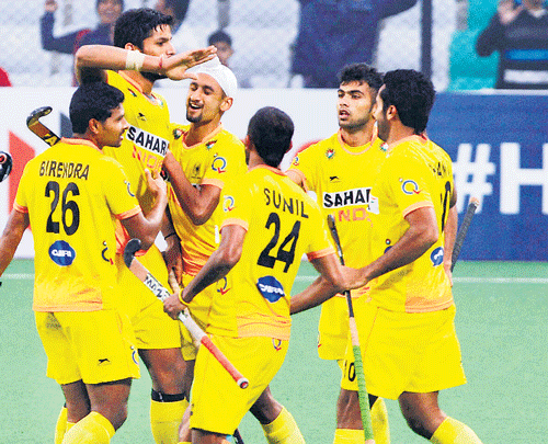 shining bright: Indian players celebrate their win over Olympic champions Germany in a play-off match of the World League Final in New Delhi on Friday. PTI