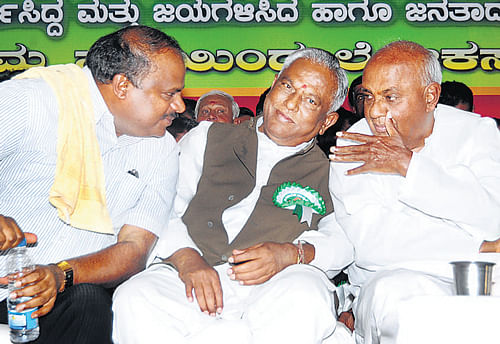 Former prime minister H D Deve Gowda in conversation with former chief minister H D Kumaraswamy as JD(S) State president A Krishnappa (Centre) looks on at the Palace Grounds in Bangalore on Friday. DH Photo