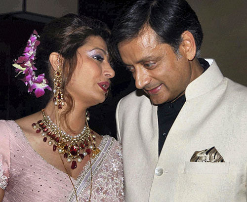 In this file photo, Sunanda Pushkar speaks to her husband Shashi Tharoor at their wedding reception in New Delhi. AP