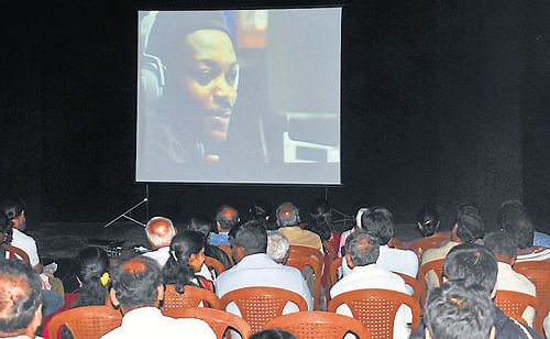 Audience are seen watching the South African documentary 'Amandla' during the film festival, in Mysore, on Friday. DH&#8200;PHOTO
