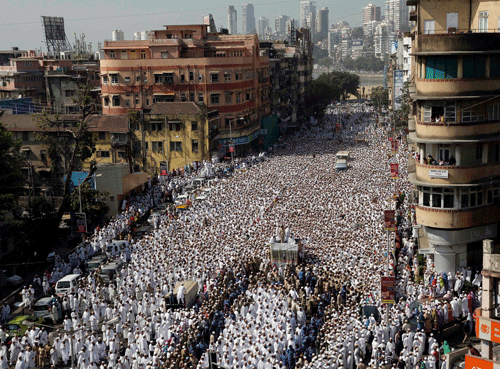 Indian Muslims join the funeral procession of the head of the Dawoodi Bohra Muslim community Syedna Mohammed Burhanuddin in Mumbai, India, Saturday, Jan. 18, 2014. A pre-dawn stampede killed more than a dozen people Saturday as tens of thousands of people gathered to mourn the death of Muslim spiritual leader Burhanuddin in the India's financial capital, police said. Burhanuddin died Friday at the age of 102. (AP Photo)