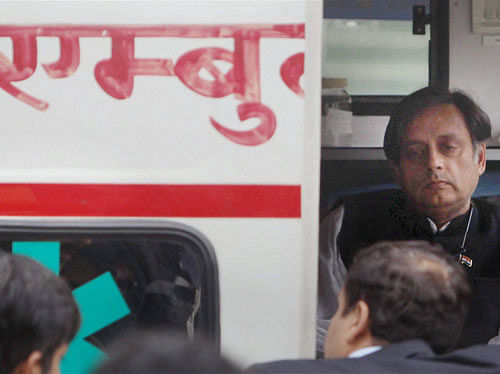 Sunanda Pushkar's husband Union minister Shashi Tharoor in an ambulance while taking away her body from the AIIMS in New Delhi on Saturday. PTI Photo