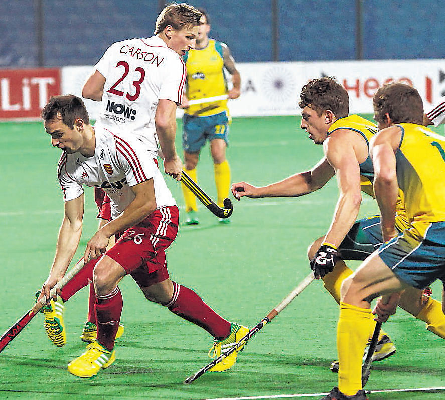 England's Nick Catlin (second from left) dribbles past Australia players in the bronze medal play-off match of the World League Final. Photo courtesy/ FIH
