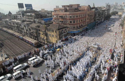 Bohra community members participate in the funeral procession of their spiritual leader Syedna Mohammed Burhanuddin in south Mumbai on Saturday. PTI Photo
