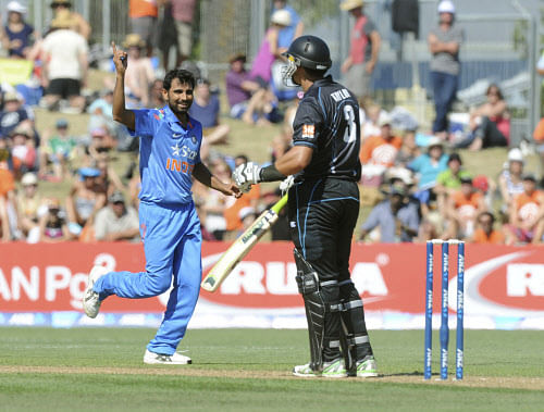 Mohammed Shami, left, celebrates after dismissing New Zealand's Ross Taylor for 52 during their first one-day international cricket match, at McLean Park, in Napier, New Zealand, Sunday, Jan.19, 2014. (AP Photo)