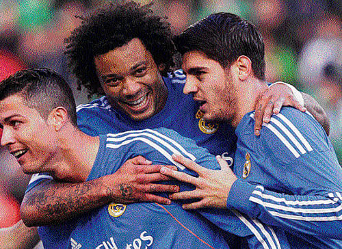 star power Real Madrid's Cristiano Ronaldo (left) celebrates with Marcelo (centre) and Alvaro Morata after scoring against Real Betis during their La Liga tie on Saturday. AP