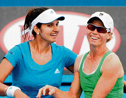 Jubilant Sania Mirza and Cara Black celebrate their win. AP