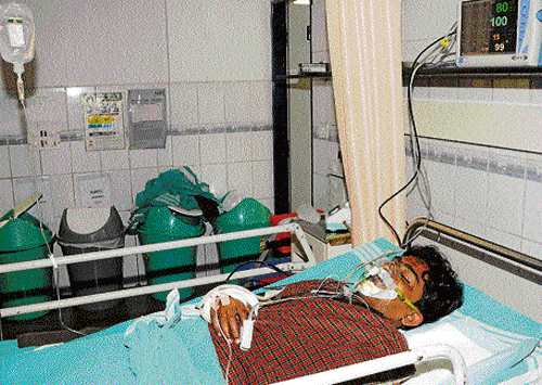 traumatic: Uma Mahesh, a passenger injured in the accident  near Hoskote, being treated at a hospital in the City on Monday.   dh photo