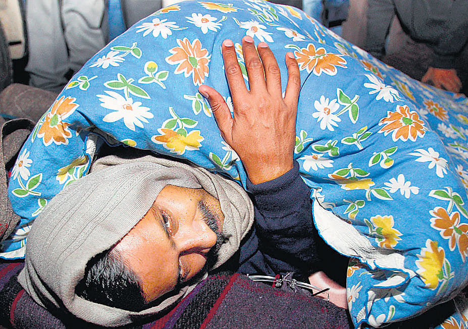 Delhi Chief Minister Arvind Kejriwal rests during his dharna in New Delhi on Monday. PTI