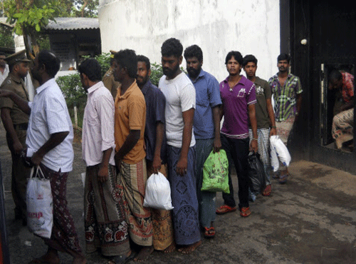 In this Monday, Jan. 13, 2014 photo, a group of Indian fishermen line up after their release from a jail in Trincolamee, Sri Lanka. Sri Lankan authorities had said they have freed 52 Indian fishermen detained for poaching following India's release of 20 Sri Lankan fishermen, in a sign of easing tensions between the two countries over the contentious issue. (AP Photo)