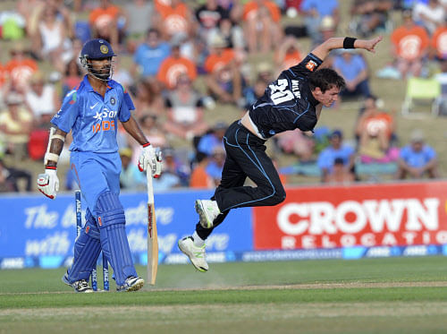 New Zealand's Adam Milne bowls past India's Shikhar Dhawan, left, in their first one day international cricket match at McLean Park in Napier, New Zealand, Sunday, Jan. 19, 2014. (AP Photo)