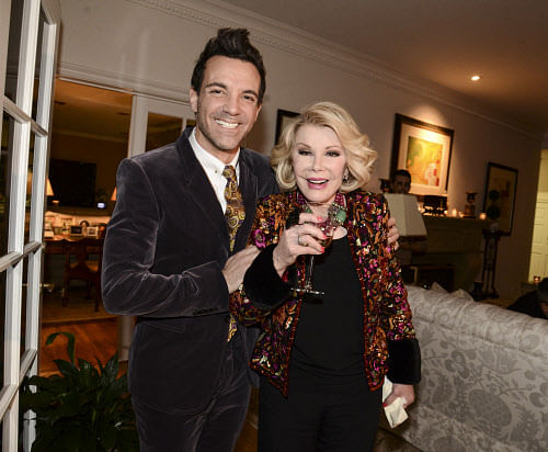 Television personality George Kotsiopoulos, left, and comedian Joan Rivers pose together at the 'Glamorous By George' book launch hosted by Joan and Melissa Rivers on Monday, Jan. 13, 2014, in Los Angeles. AP