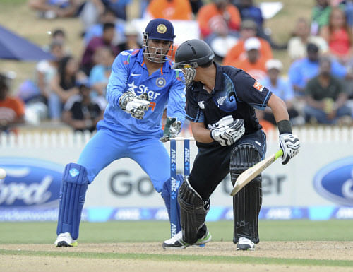 MS Dhoni, left, attempts a stumping of New Zealand's Ross Taylor in the second one-day International cricket match at Seddon Park in Hamilton, New Zealand, Wednesday, Jan. 22, 2014. (AP Photo)