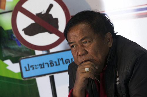 Kwanchai Praipana, a pro-government 'red shirt' leader, is seen during an interview with Reuters at a radio station he owns in Udon Thani, in this picture taken January 21, 2014. Kwanchai was shot and wounded on Wednesday in Thailand's northeast, a stronghold of Prime Minister Yingluck Shinawatra, as a state of emergency began in and around the capital Bangkok where protesters are trying to force her to resign. The government issued the 60-day emergency decree late on Tuesday, handing security agencies wide powers to detain suspects, impose a curfew and limit gatherings. Picture taken January 21, 2014. REUTERS/