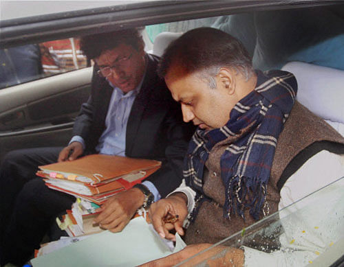 Delhi Law Minister Somnath Bharti clearing the files in his car on the second day of their dharna against police near Rail Bhavan in New Delhi on Tuesday. PTI Photo