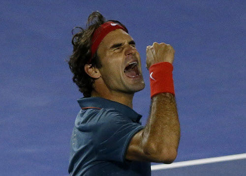 Roger Federer of Switzerland celebrates defeating Andy Murray of Britain in their men's singles quarter-final tennis match at the Australian Open 2014 tennis tournament in Melbourne January 22, 2014. REUTERS
